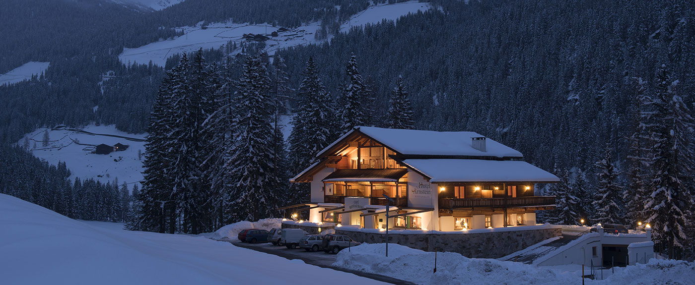 Illuminated Hotel Arnstein at dusk on a winter day