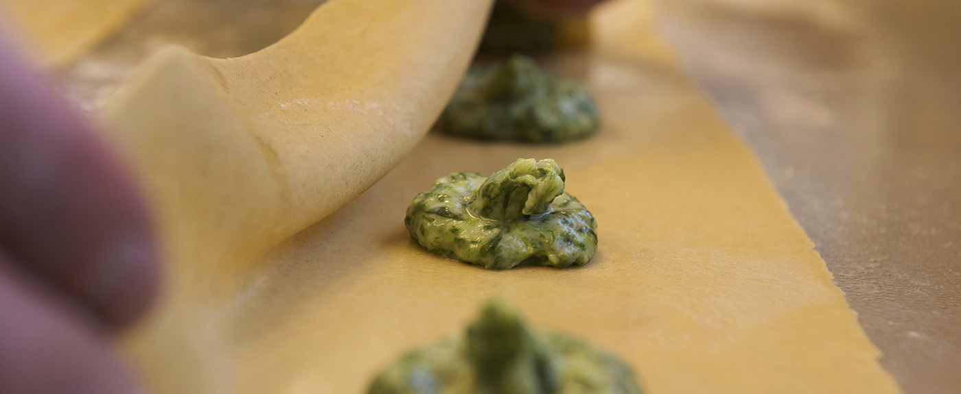 Spinatfülle auf Nudelteig, aus dem Schlutzkrapfen gemacht werden